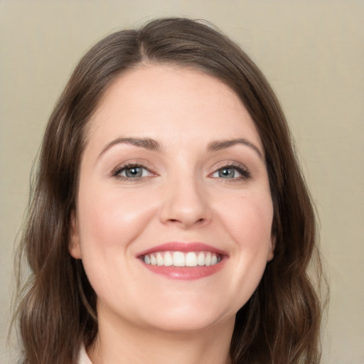 Joyful white young-adult female with medium  brown hair and green eyes