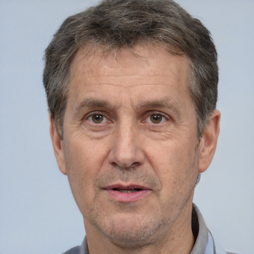 Joyful white middle-aged male with short  brown hair and brown eyes