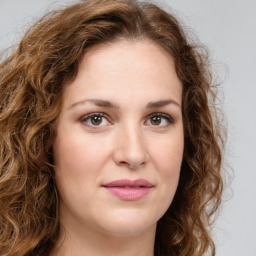 Joyful white young-adult female with long  brown hair and green eyes