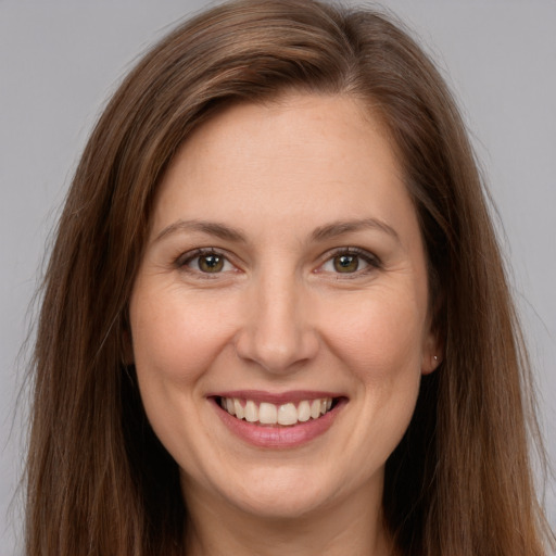 Joyful white young-adult female with long  brown hair and brown eyes