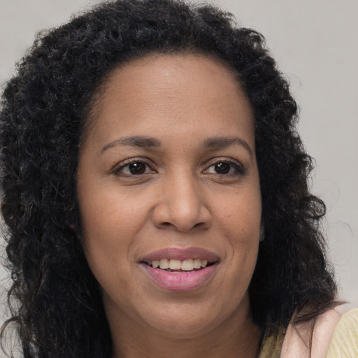 Joyful white adult female with long  brown hair and brown eyes