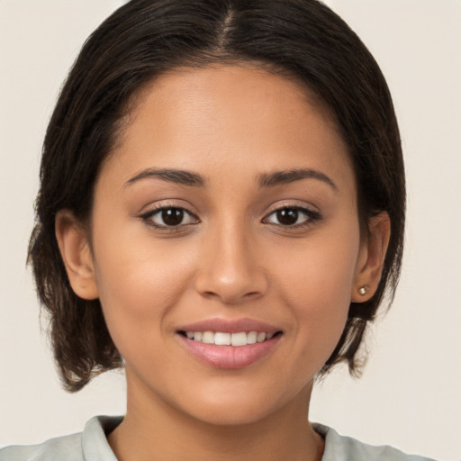 Joyful white young-adult female with medium  brown hair and brown eyes