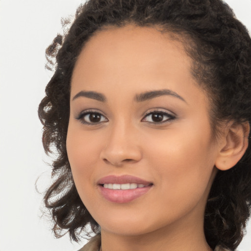 Joyful latino young-adult female with long  brown hair and brown eyes