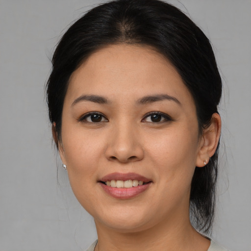 Joyful asian young-adult female with medium  brown hair and brown eyes