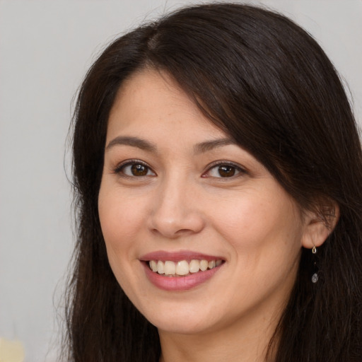 Joyful white young-adult female with long  brown hair and brown eyes