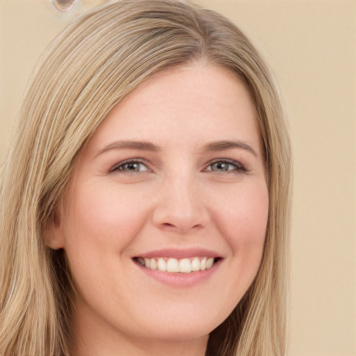 Joyful white young-adult female with long  blond hair and brown eyes