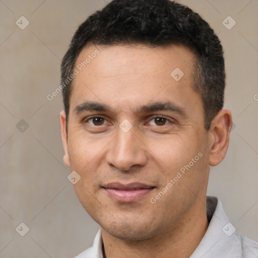 Joyful white adult male with short  black hair and brown eyes