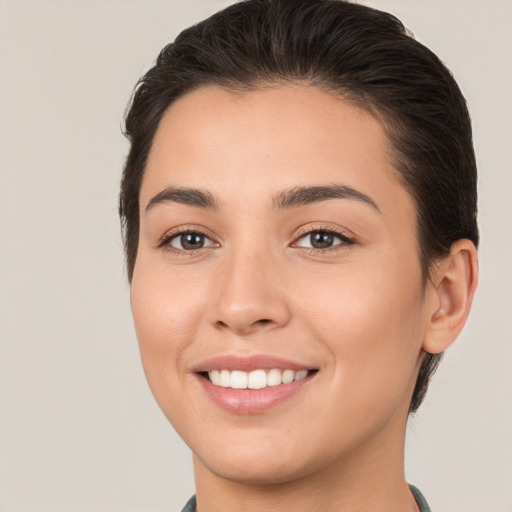 Joyful white young-adult female with medium  brown hair and brown eyes