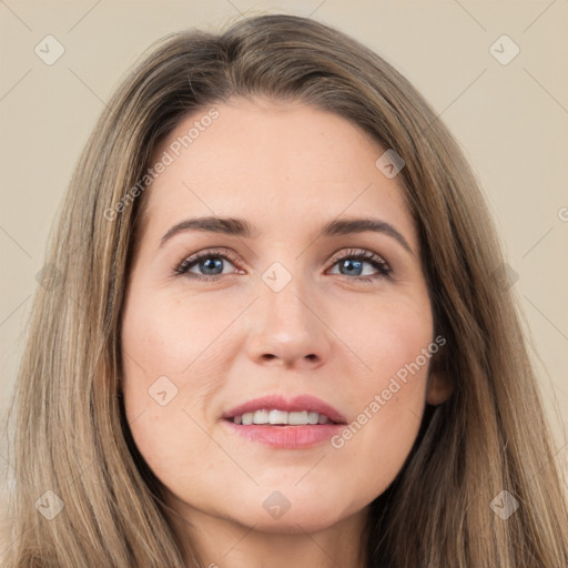 Joyful white young-adult female with long  brown hair and brown eyes