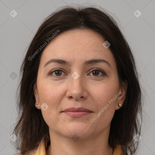 Joyful white adult female with medium  brown hair and brown eyes