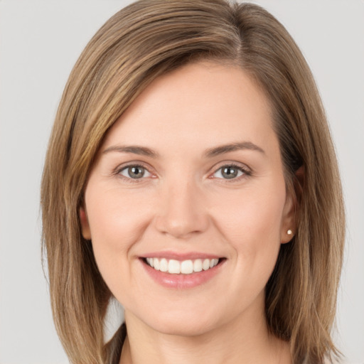 Joyful white young-adult female with long  brown hair and brown eyes