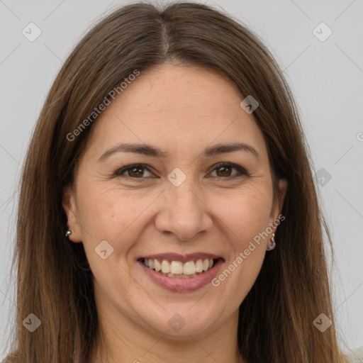 Joyful white adult female with long  brown hair and brown eyes