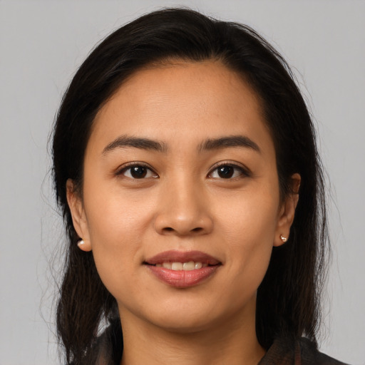 Joyful latino young-adult female with medium  brown hair and brown eyes