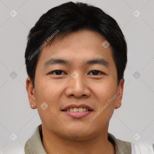 Joyful asian young-adult male with short  black hair and brown eyes