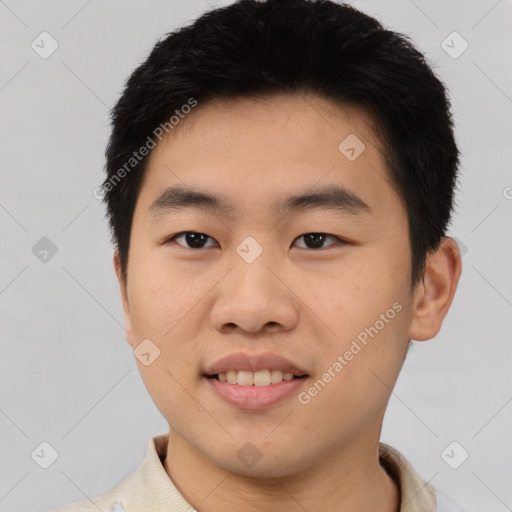 Joyful asian young-adult male with short  black hair and brown eyes