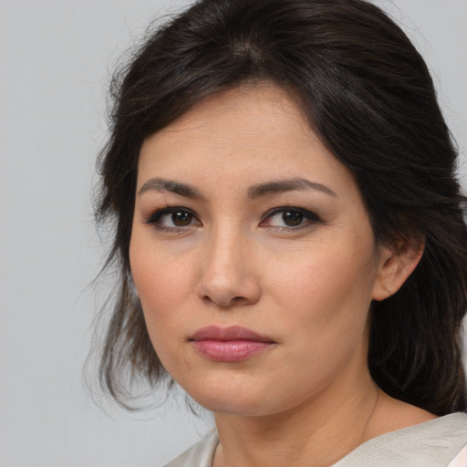 Joyful asian young-adult female with medium  brown hair and brown eyes