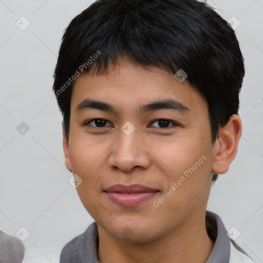 Joyful asian young-adult male with short  brown hair and brown eyes