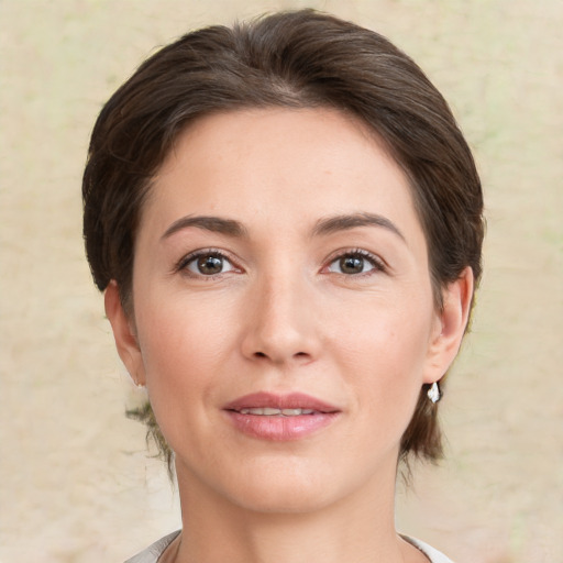 Joyful white young-adult female with medium  brown hair and brown eyes