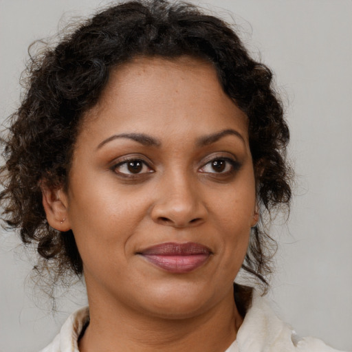 Joyful black young-adult female with medium  brown hair and brown eyes