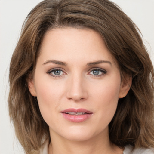 Joyful white young-adult female with medium  brown hair and green eyes