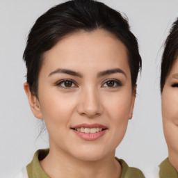 Joyful asian young-adult female with medium  brown hair and brown eyes