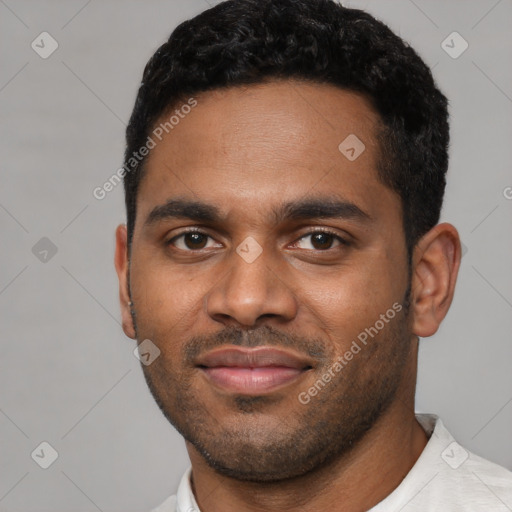 Joyful black young-adult male with short  black hair and brown eyes