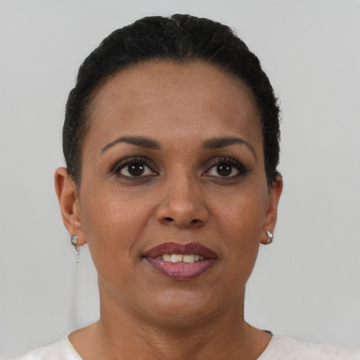 Joyful black adult female with short  brown hair and brown eyes