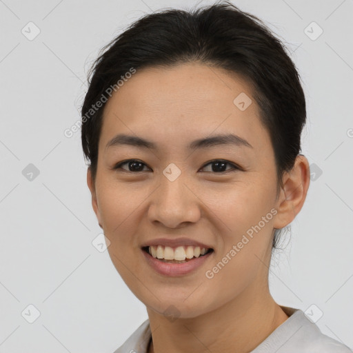 Joyful asian young-adult female with short  brown hair and brown eyes