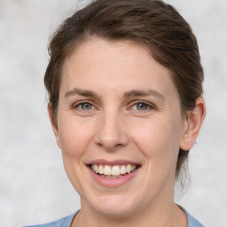 Joyful white adult female with short  brown hair and grey eyes