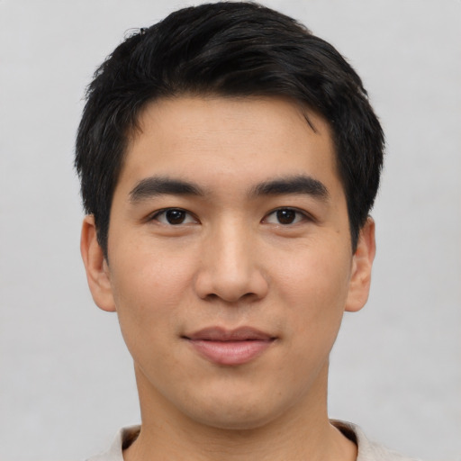 Joyful asian young-adult male with short  black hair and brown eyes
