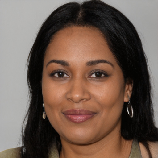 Joyful black young-adult female with long  black hair and brown eyes
