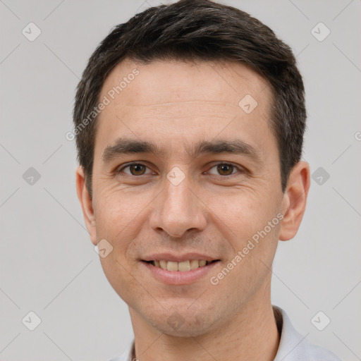 Joyful white adult male with short  brown hair and brown eyes