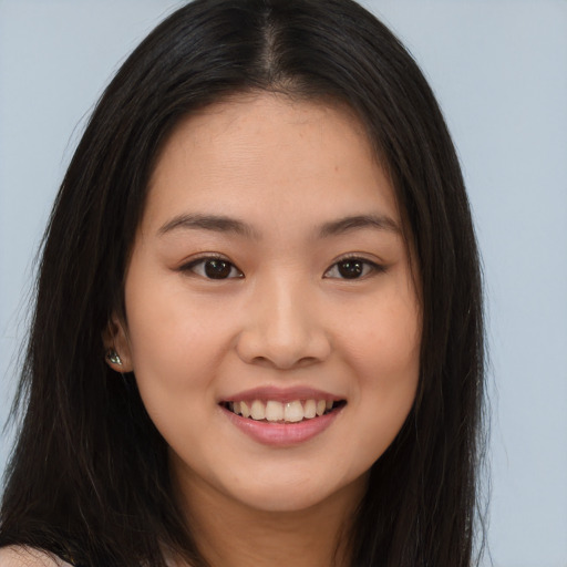Joyful asian young-adult female with long  brown hair and brown eyes