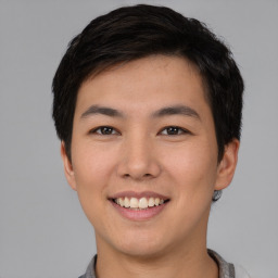 Joyful asian young-adult male with short  black hair and brown eyes