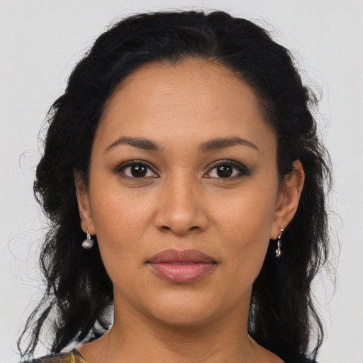 Joyful latino young-adult female with medium  black hair and brown eyes
