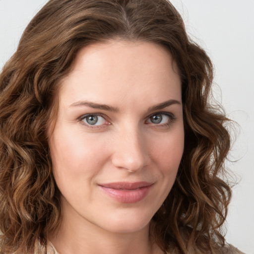 Joyful white young-adult female with long  brown hair and green eyes