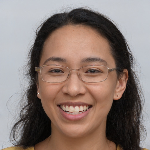 Joyful white adult female with long  brown hair and brown eyes