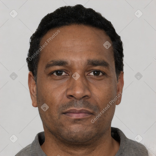 Neutral latino adult male with short  black hair and brown eyes