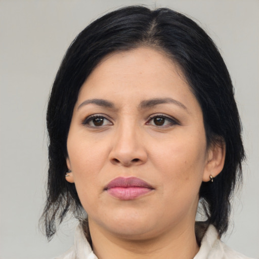 Joyful asian adult female with medium  brown hair and brown eyes