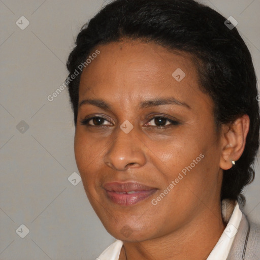 Joyful black adult female with medium  brown hair and brown eyes