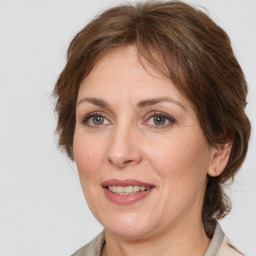 Joyful white adult female with medium  brown hair and grey eyes