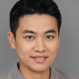 Joyful latino young-adult male with short  brown hair and brown eyes