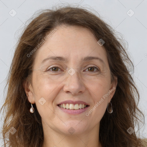 Joyful white adult female with long  brown hair and grey eyes