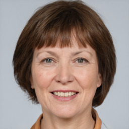 Joyful white adult female with medium  brown hair and grey eyes