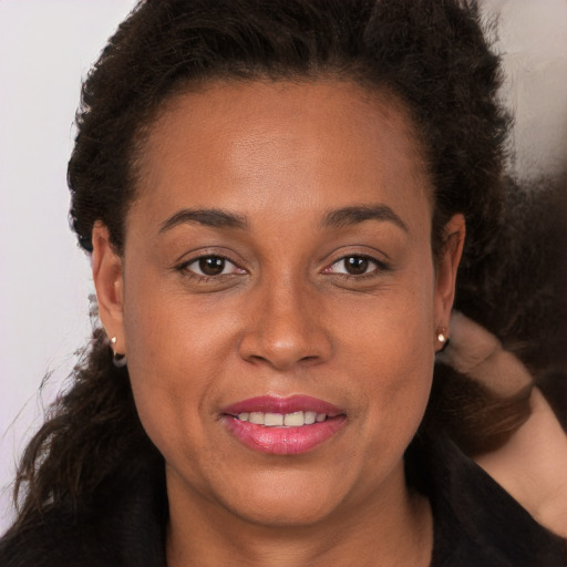 Joyful white young-adult female with long  brown hair and brown eyes