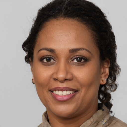 Joyful latino adult female with long  brown hair and brown eyes
