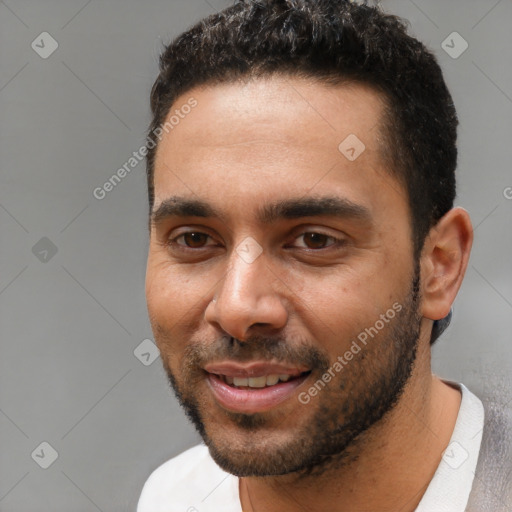 Joyful black young-adult male with short  black hair and brown eyes