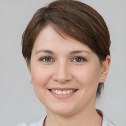 Joyful white young-adult female with medium  brown hair and brown eyes