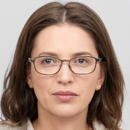 Joyful white adult female with medium  brown hair and grey eyes