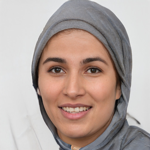 Joyful white young-adult female with medium  black hair and brown eyes